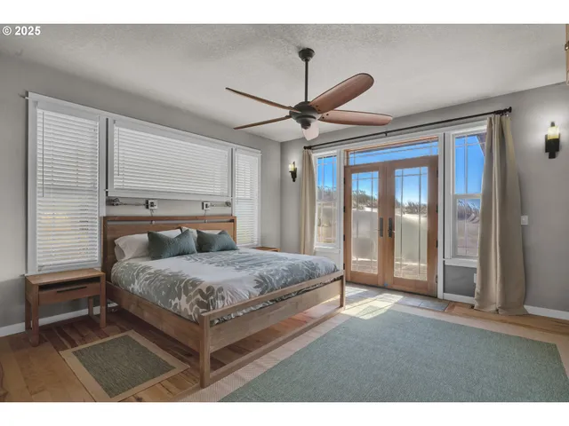 a bedroom with a bed and a ceiling fan