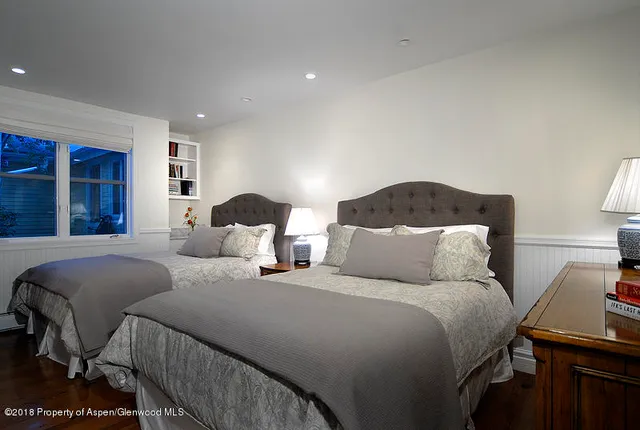 a bedroom with double bed and a window