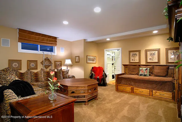 a living room with furniture and a lamp