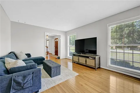 a living room with furniture and a flat screen tv