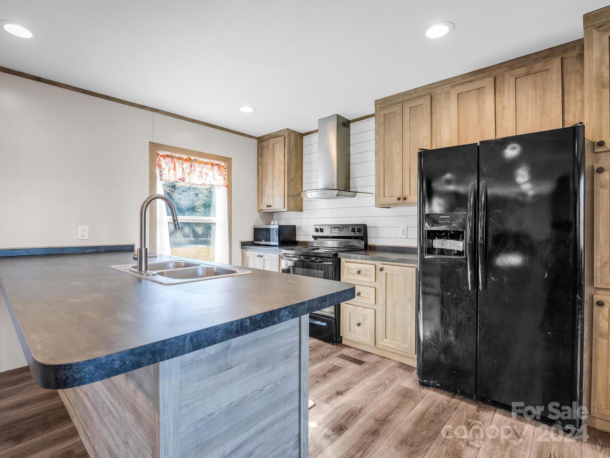 667 Salem Church Road Bostic, NC 28018 - Photo 11 of 34 a kitchen with a refrigerator and a sink