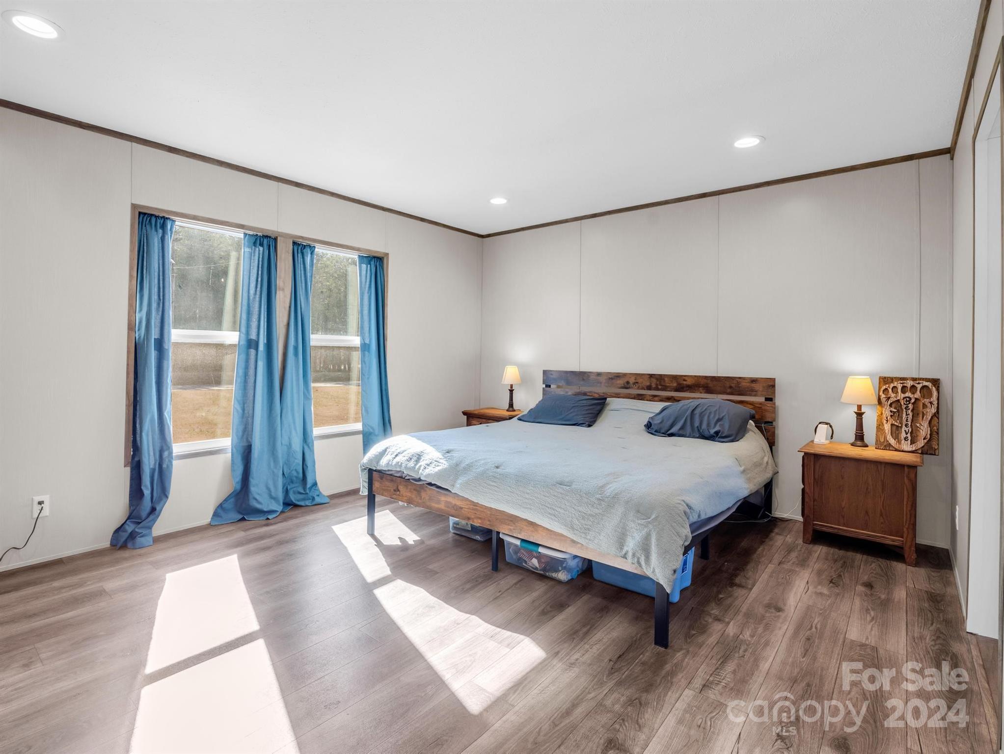 667 Salem Church Road Bostic, NC 28018 - Photo 17 of 34 a bedroom with a bed and wooden floor