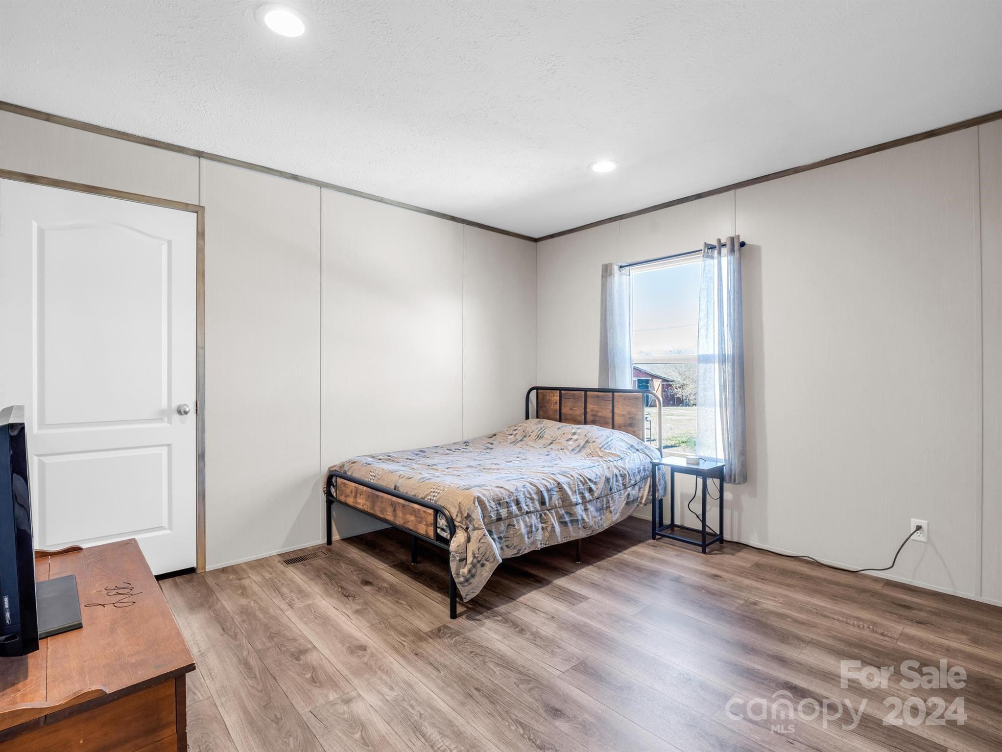 667 Salem Church Road Bostic, NC 28018 - Photo 23 of 34 a bedroom with a bed and a flat screen tv