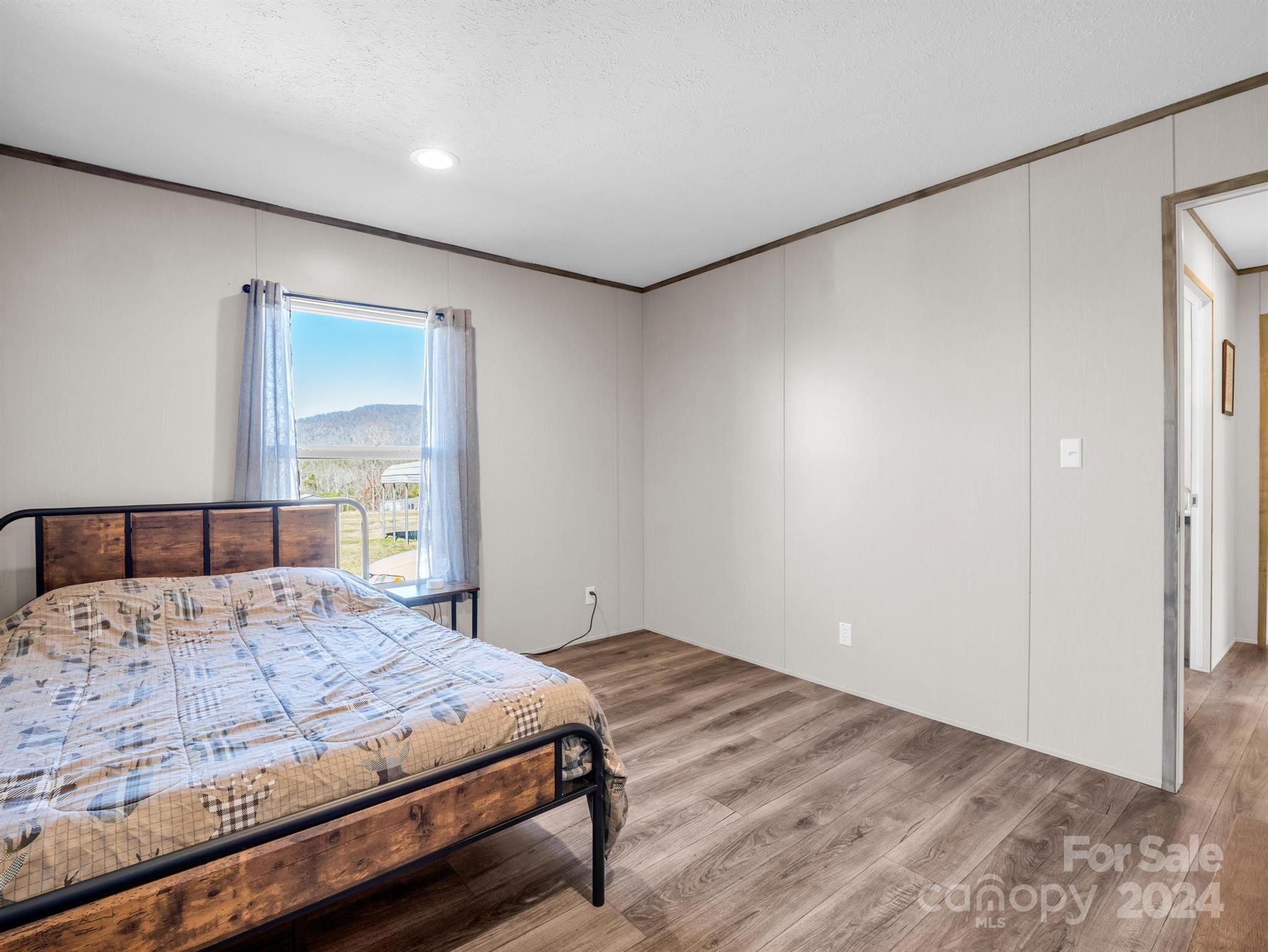 667 Salem Church Road Bostic, NC 28018 - Photo 24 of 34 a bedroom with a large bed and wooden floor