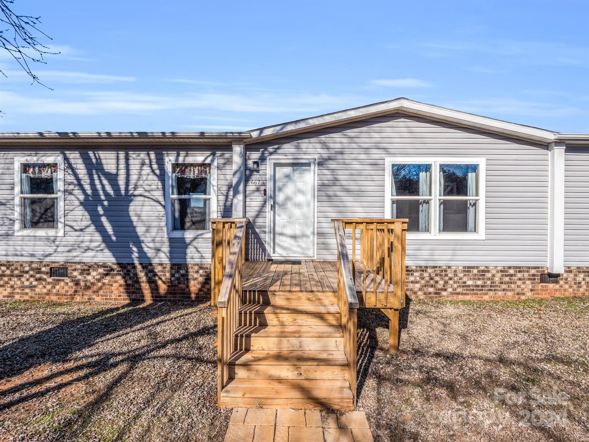 667 Salem Church Road Bostic, NC 28018 - Photo 5 of 34 a front view of a house with outdoor seating