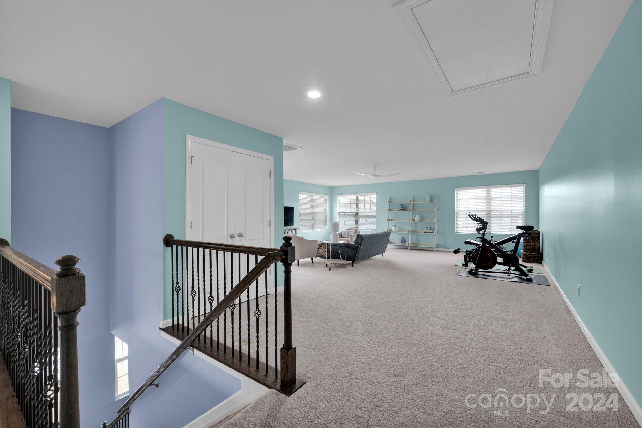 12834 Robert Walker Drive Davidson, NC 28036 - Photo 17 of 27 a view of a livingroom with furniture and gym equipment