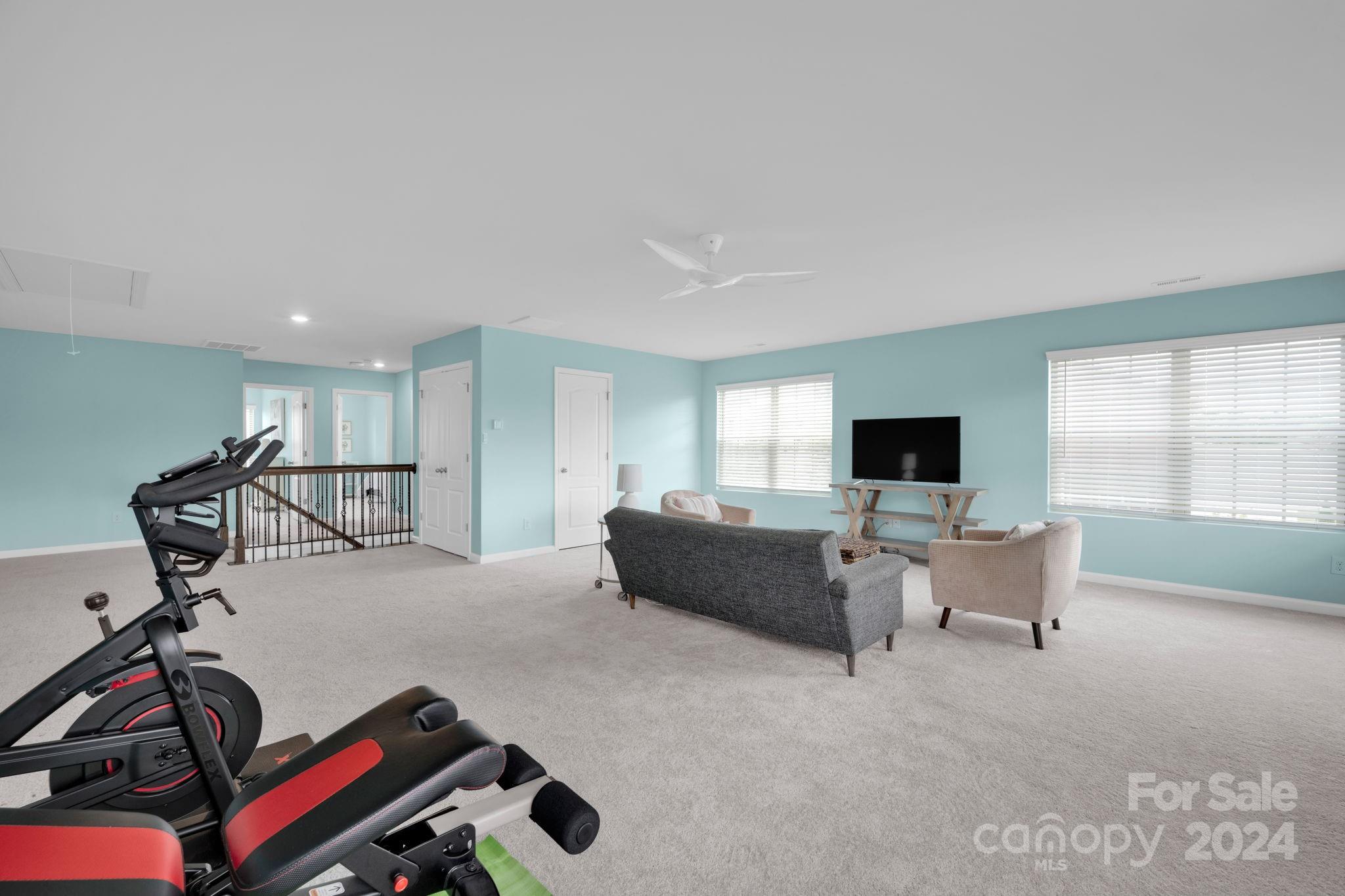 12834 Robert Walker Drive Davidson, NC 28036 - Photo 18 of 27 a living room with furniture and a flat screen tv