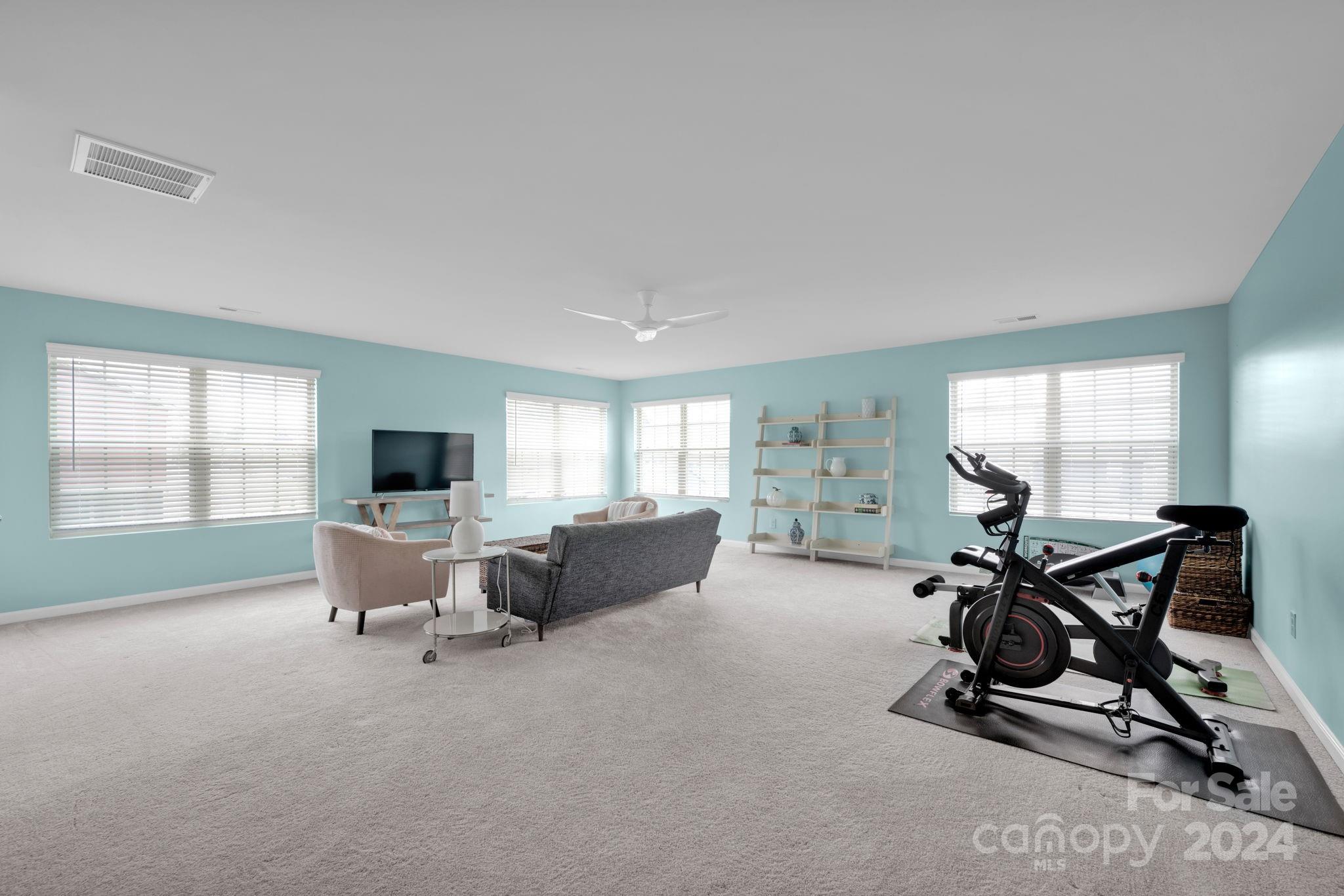 12834 Robert Walker Drive Davidson, NC 28036 - Photo 19 of 27 a living room with furniture and a flat screen tv