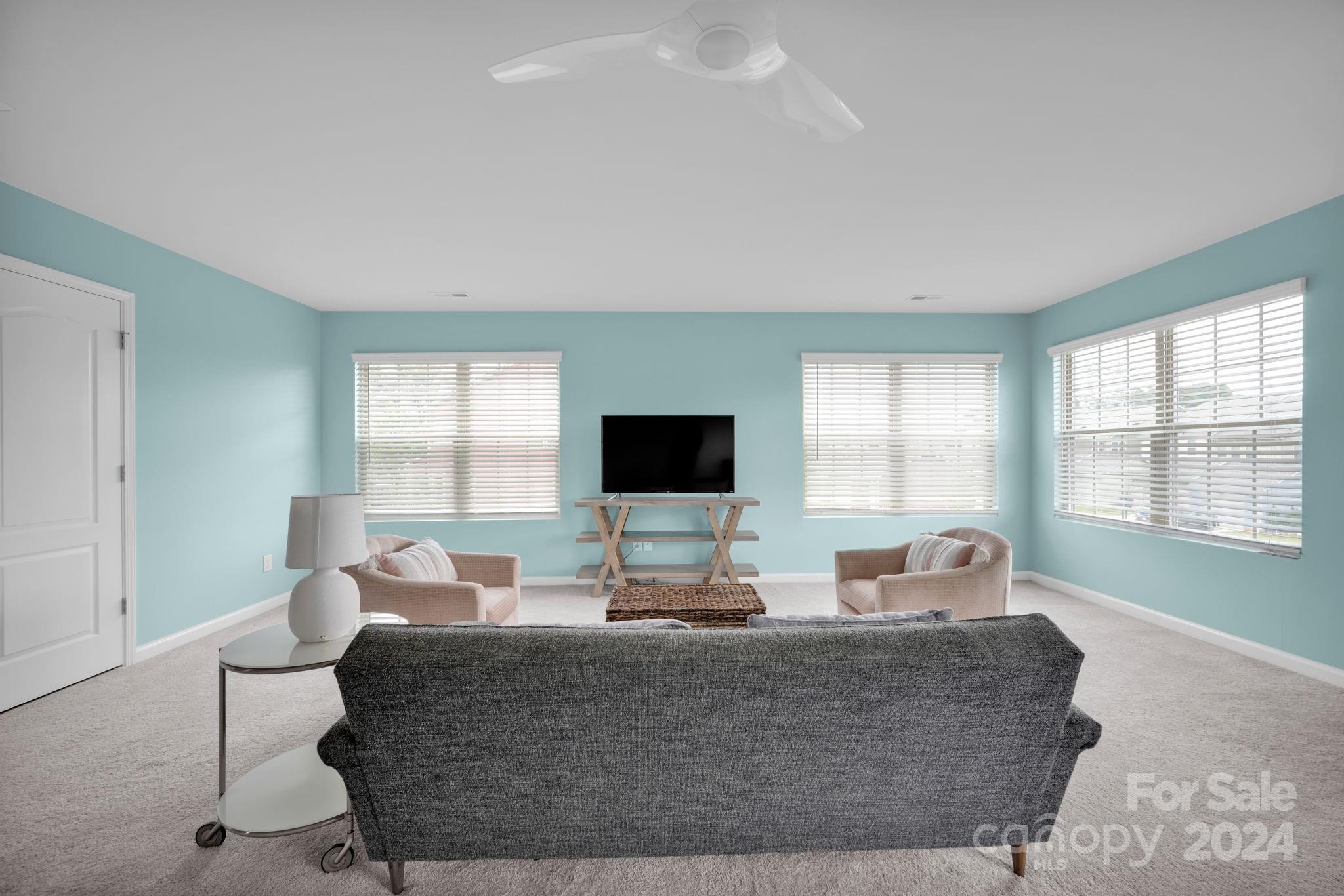 12834 Robert Walker Drive Davidson, NC 28036 - Photo 20 of 27 a living room with furniture and a flat screen tv