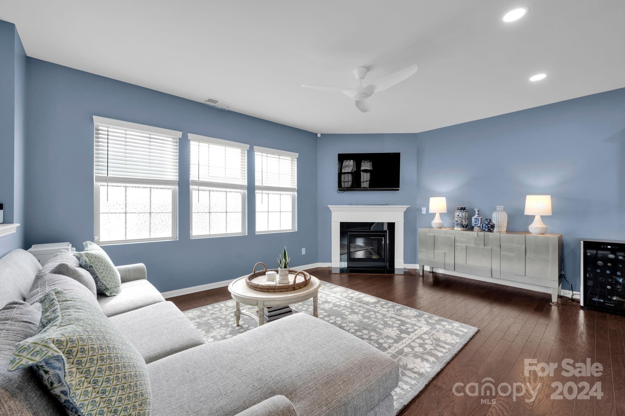 12834 Robert Walker Drive Davidson, NC 28036 - Photo 5 of 27 a living room with furniture and a fireplace