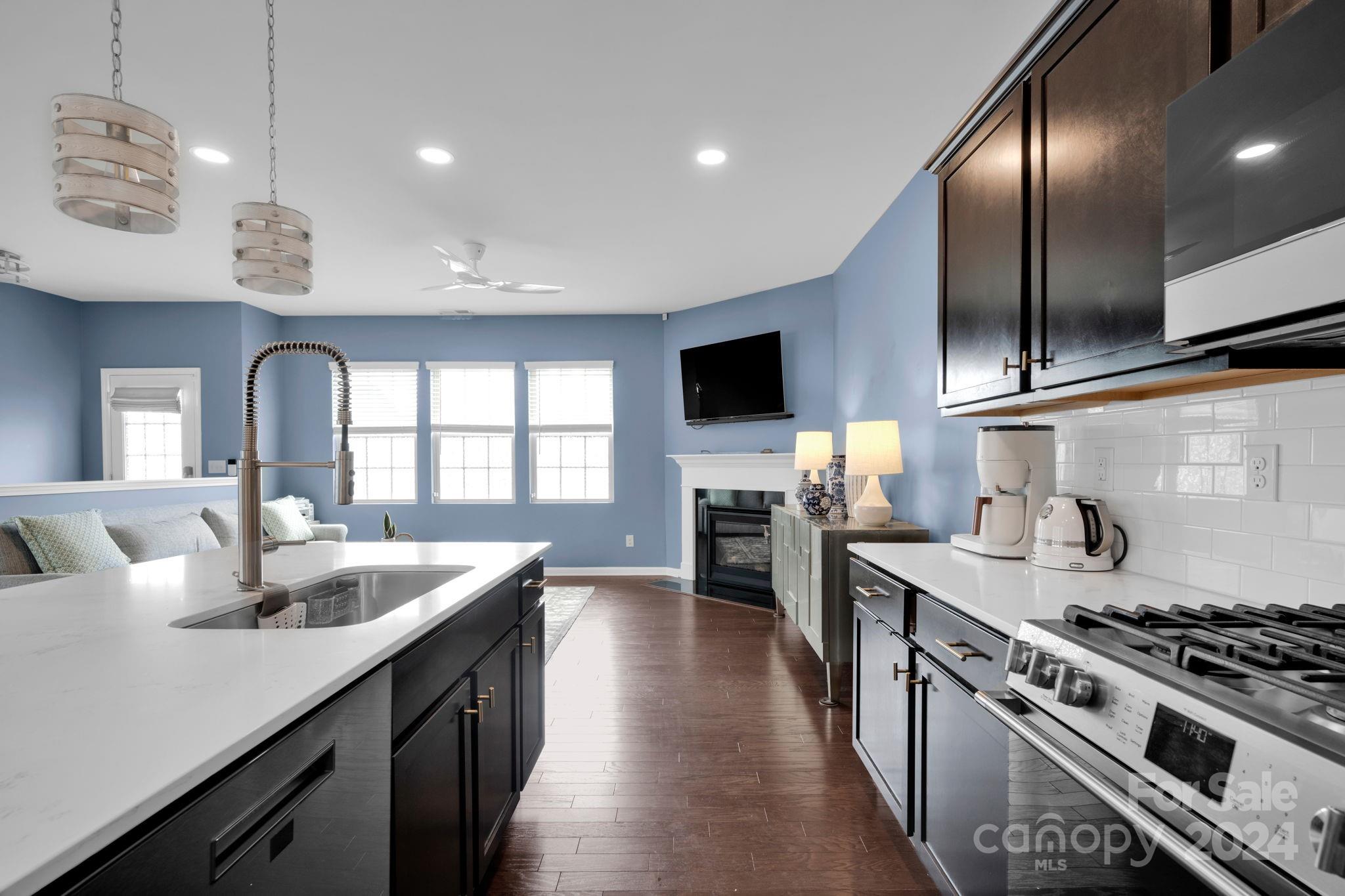 12834 Robert Walker Drive Davidson, NC 28036 - Photo 6 of 27 a kitchen with stainless steel appliances granite countertop a stove and a sink