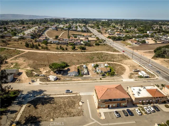 an aerial view of a residential building and ocean view