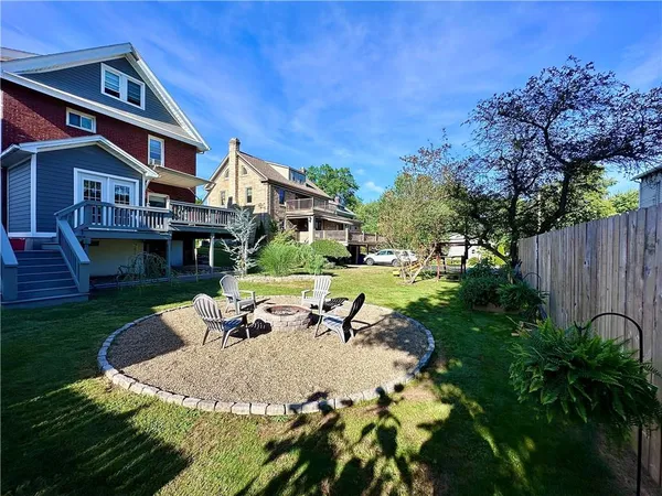 a view of a house with backyard and sitting area