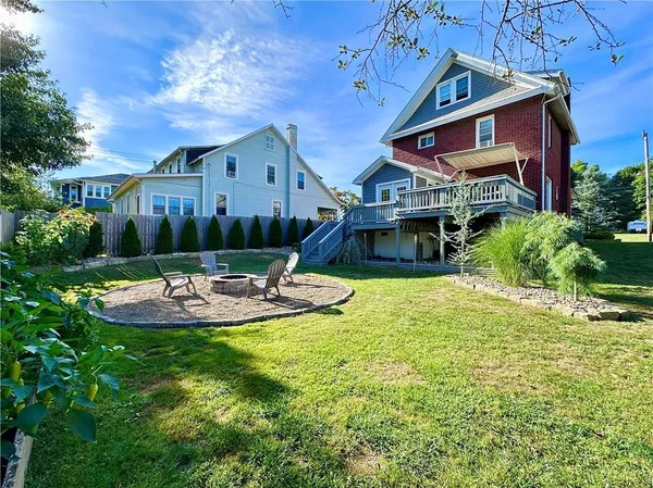 a view of a house with swimming pool and furniture