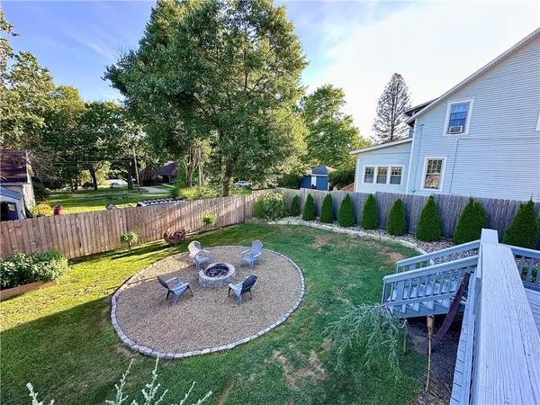 a backyard of a house with table and chairs