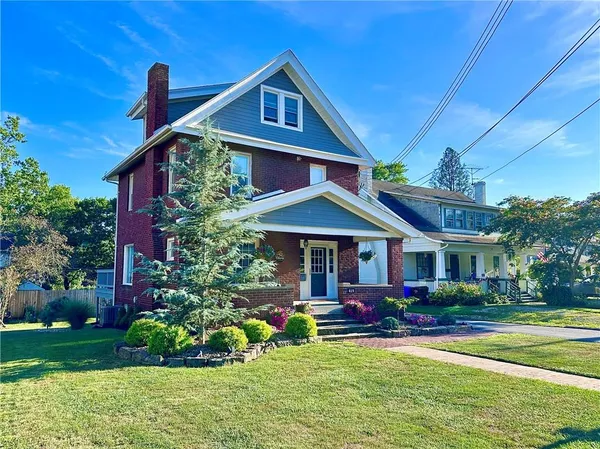 a front view of a house with a garden