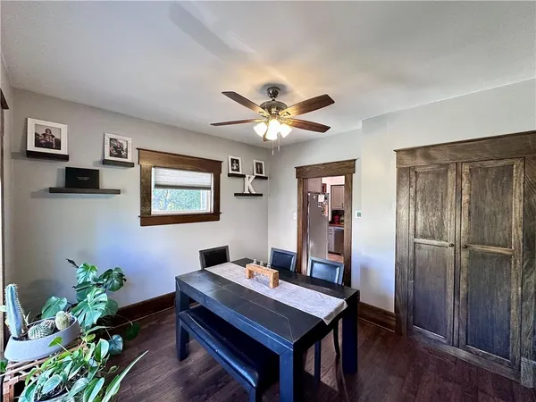 a room with chandelier fan and wooden floor