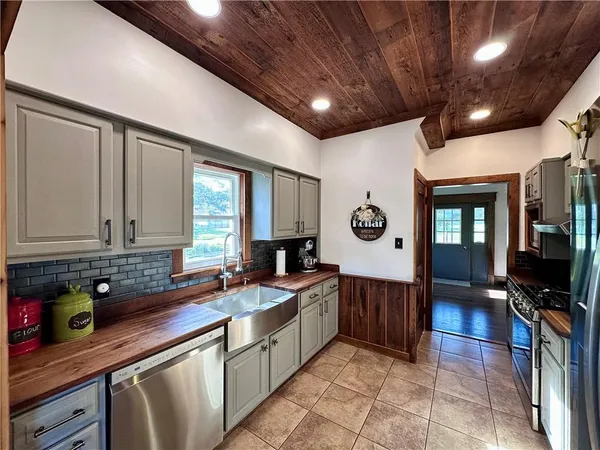 a kitchen with a sink window and cabinets