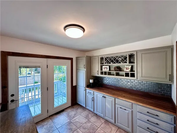 a large kitchen with granite countertop a large window and a sink