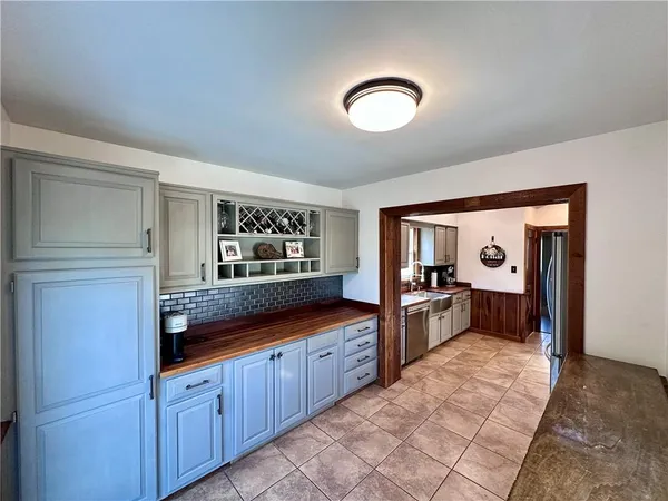 a large kitchen with stainless steel appliances granite countertop a large counter top and wooden floors