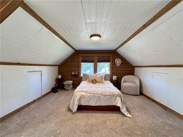 a spacious bedroom with a bed and a large window