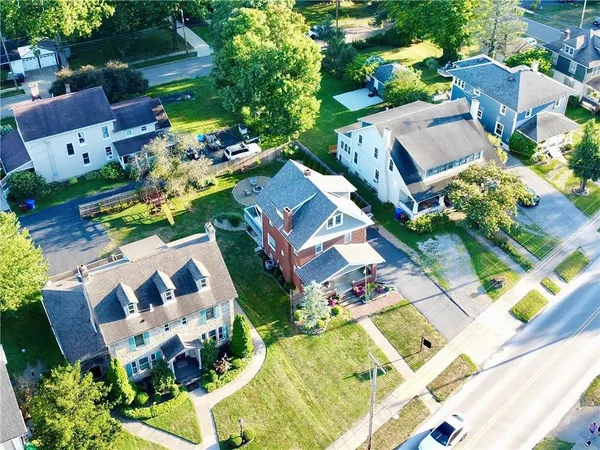 an aerial view of multiple houses with yard