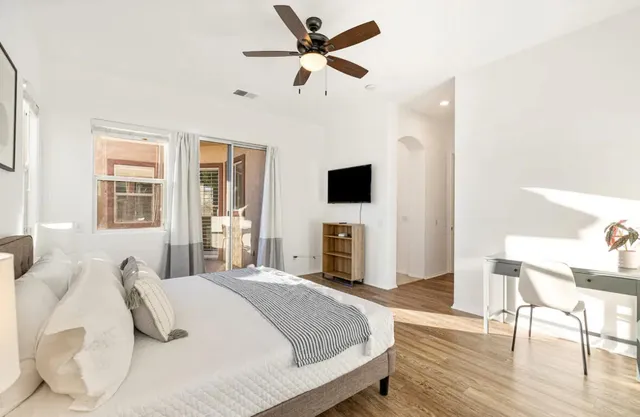 a bedroom with a bed and a flat screen tv