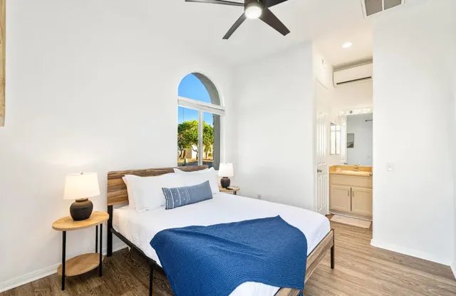 a bedroom with a bed and a chair