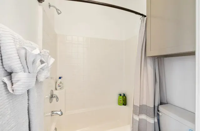 a bathroom with a bathtub and shower