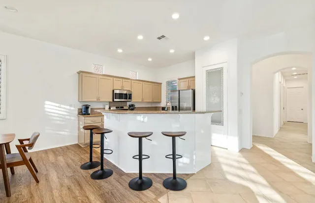 a kitchen with stainless steel appliances kitchen island granite countertop a sink and cabinets
