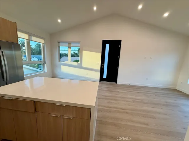a view of a kitchen with wooden floor and a sink
