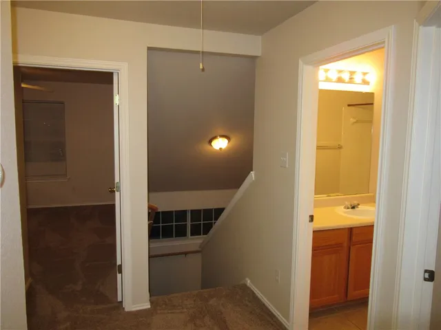 a view of a hallway with wooden floor and entryway