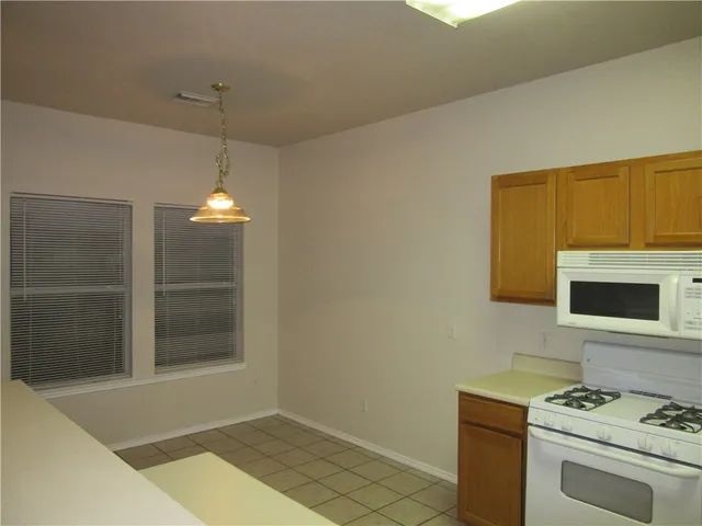 a kitchen that has a stove and a microwave