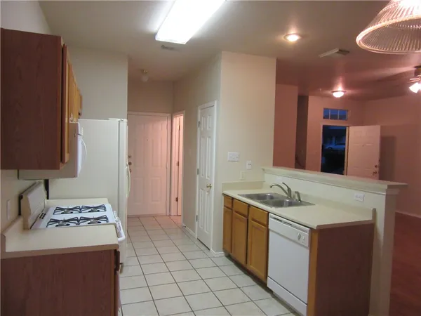 a kitchen with a sink stove and cabinets
