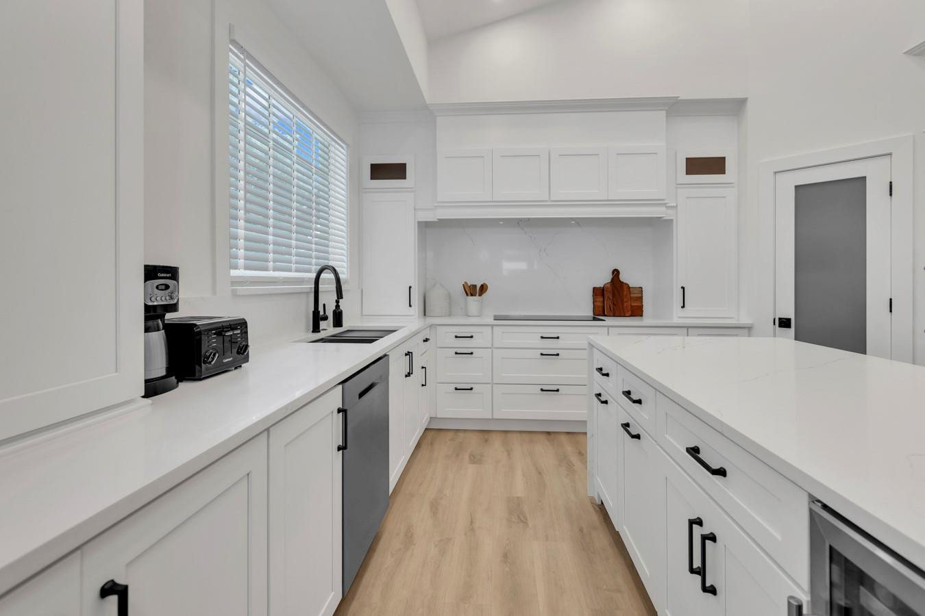 6391 Northwest 23rd Lane Boca Raton, FL 33434 - Photo 12 of 49 a kitchen with white cabinets sink and window