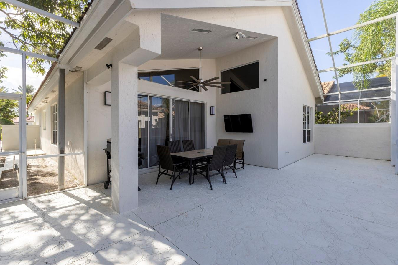 6391 Northwest 23rd Lane Boca Raton, FL 33434 - Photo 28 of 49 a view of a house with a porch and furniture