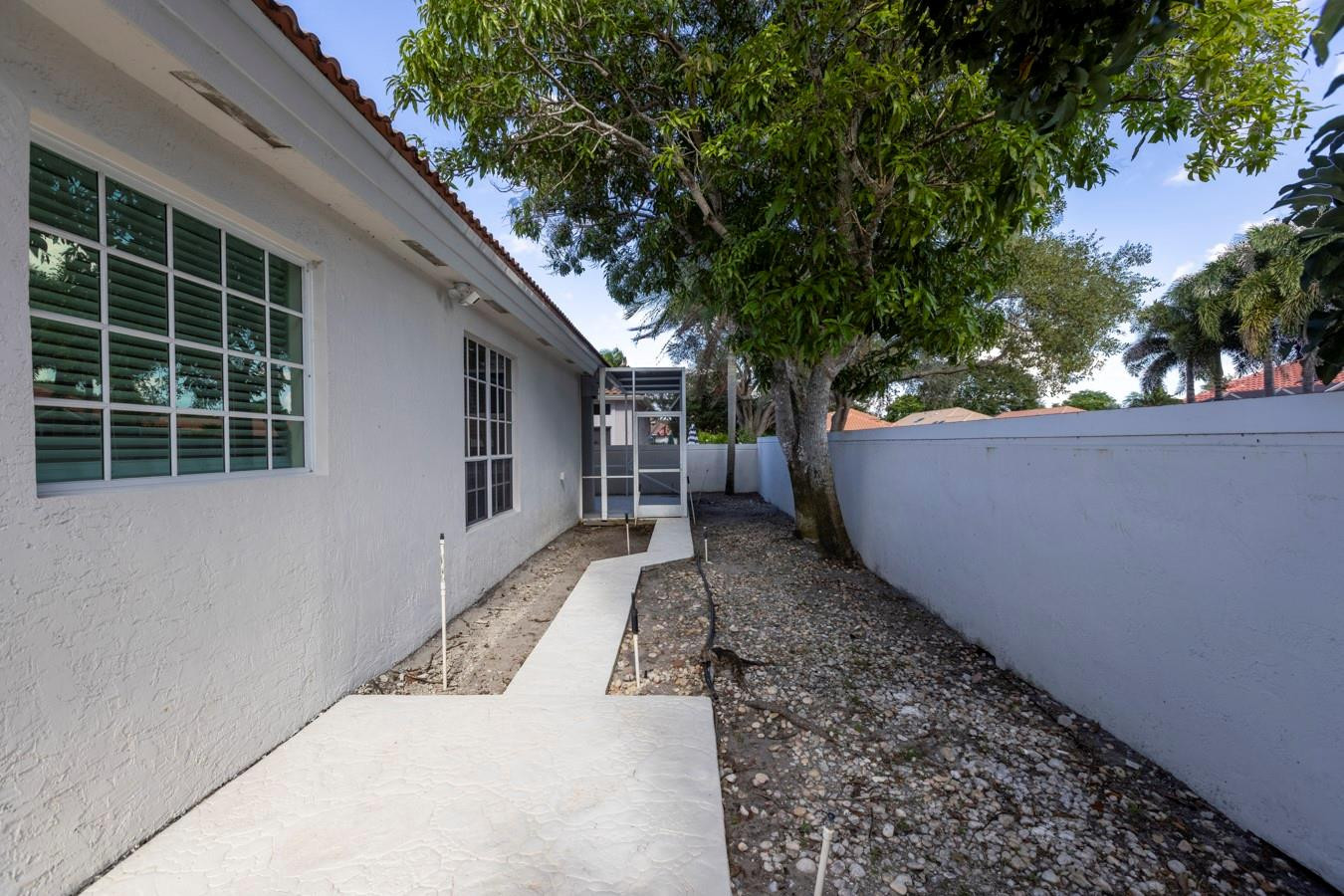 6391 Northwest 23rd Lane Boca Raton, FL 33434 - Photo 30 of 49 a view of a backyard with a large tree