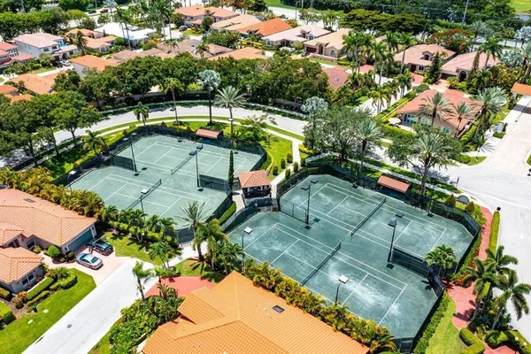 an aerial view of a house with a yard basket ball court and outdoor seating