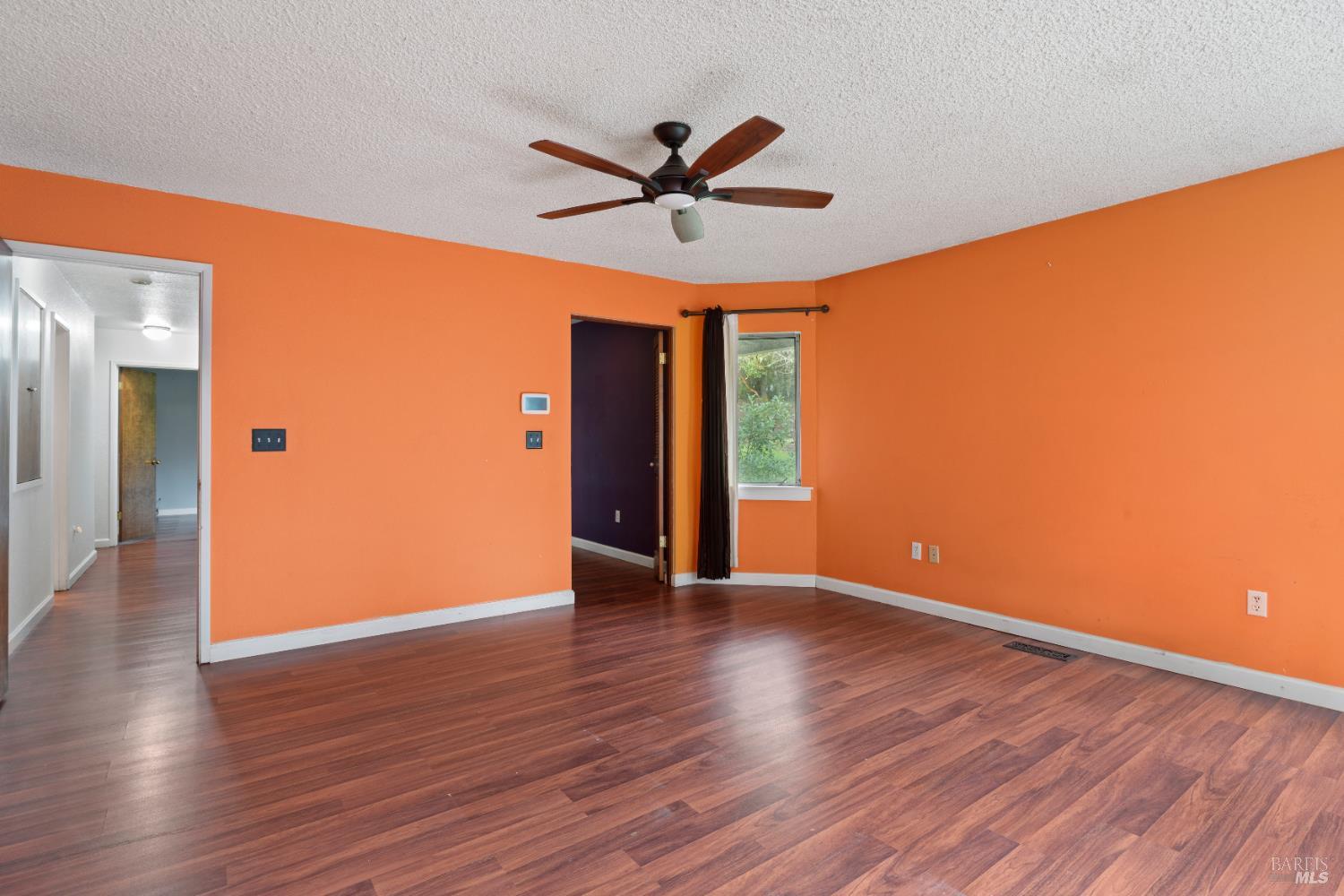 681 Branscomb Road Laytonville, CA 95454 - Photo 15 of 27 a view of an empty room with wooden floor and a ceiling fan