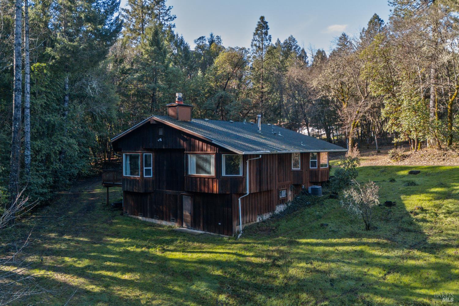 681 Branscomb Road Laytonville, CA 95454 - Photo 19 of 27 a view of a house with a small yard and large trees
