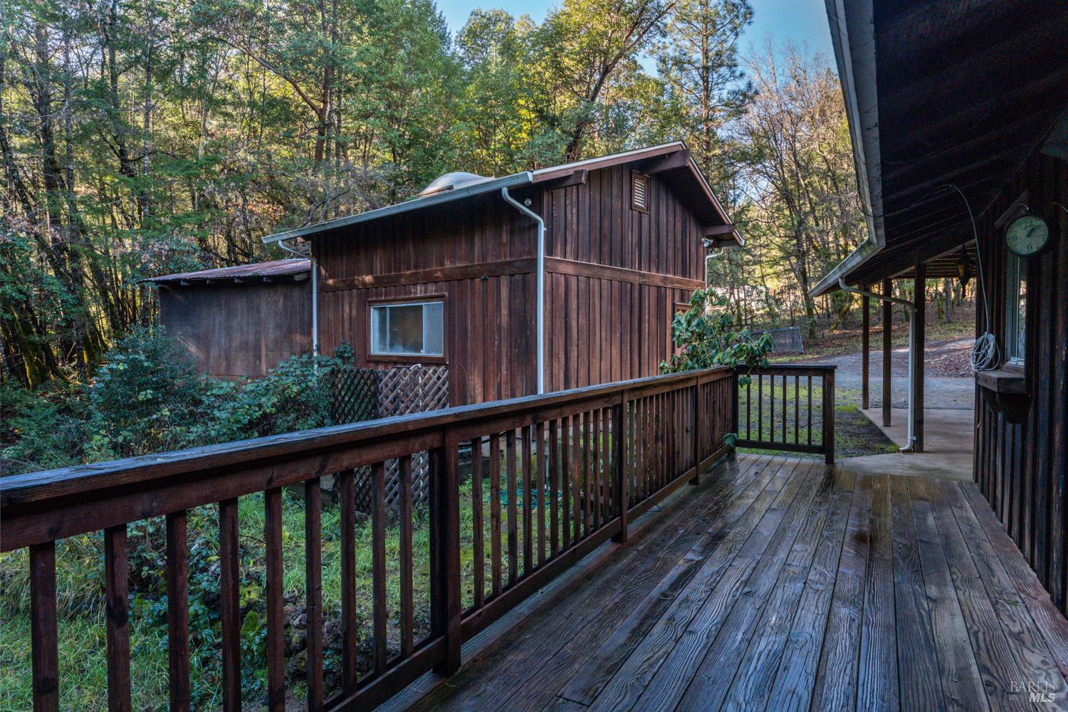 681 Branscomb Road Laytonville, CA 95454 - Photo 21 of 27 a view of a wooden house with a deck
