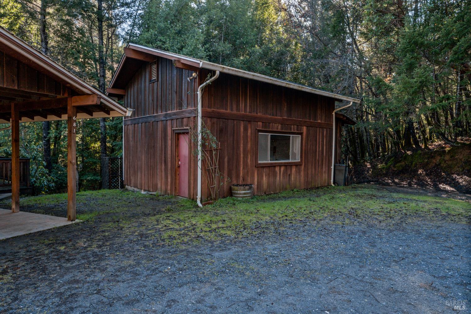 681 Branscomb Road Laytonville, CA 95454 - Photo 22 of 27 a wooden house with a yard and large trees