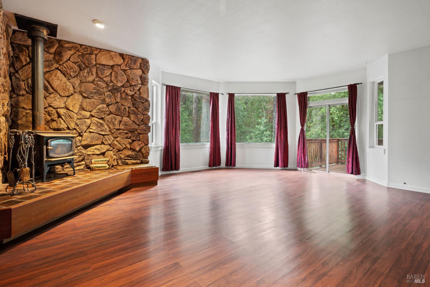 681 Branscomb Road Laytonville, CA 95454 - Photo 4 of 27 a view of an empty room with a window and wooden floor
