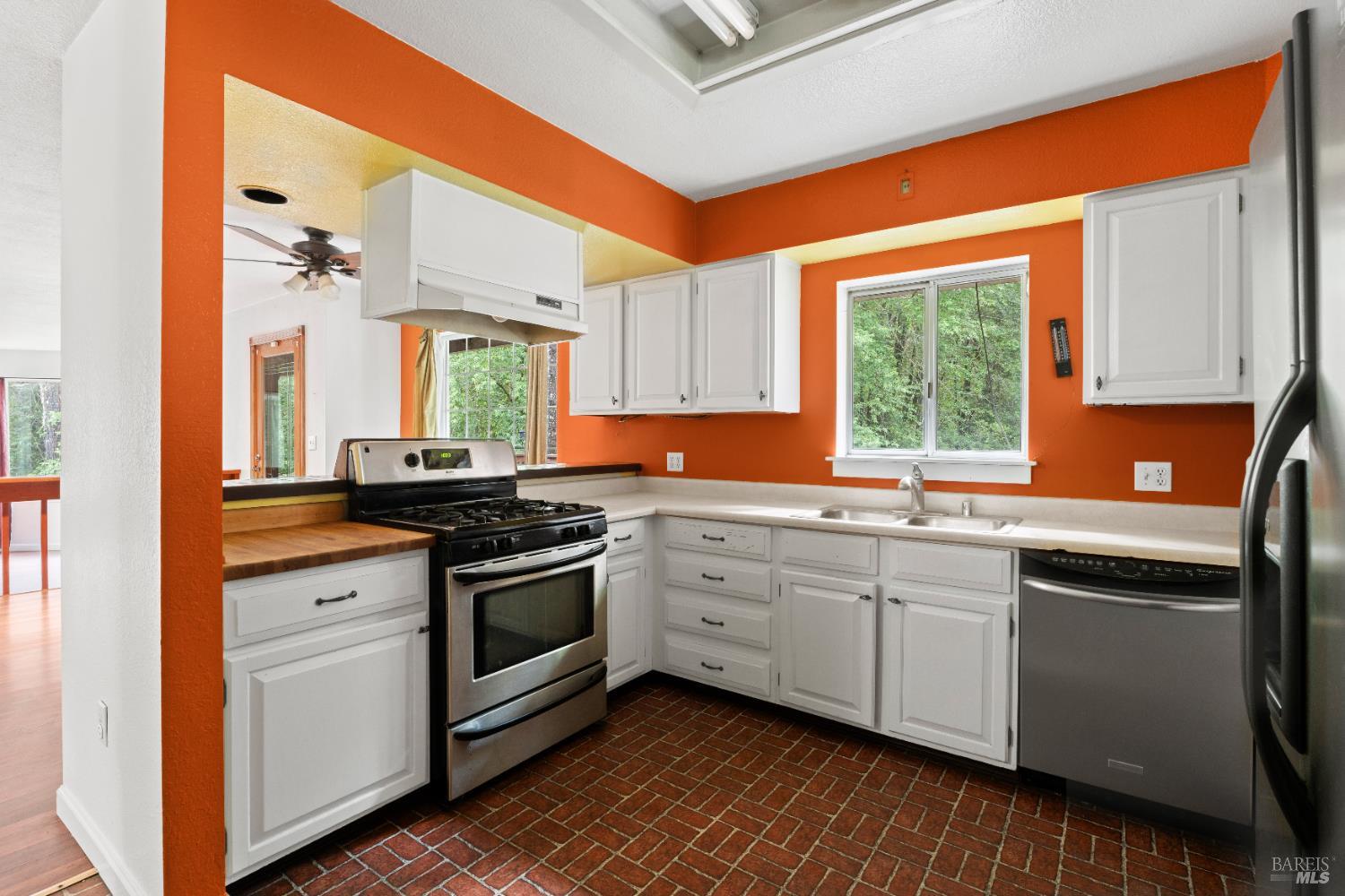 681 Branscomb Road Laytonville, CA 95454 - Photo 9 of 27 a kitchen with stainless steel appliances granite countertop a stove a sink and a refrigerator