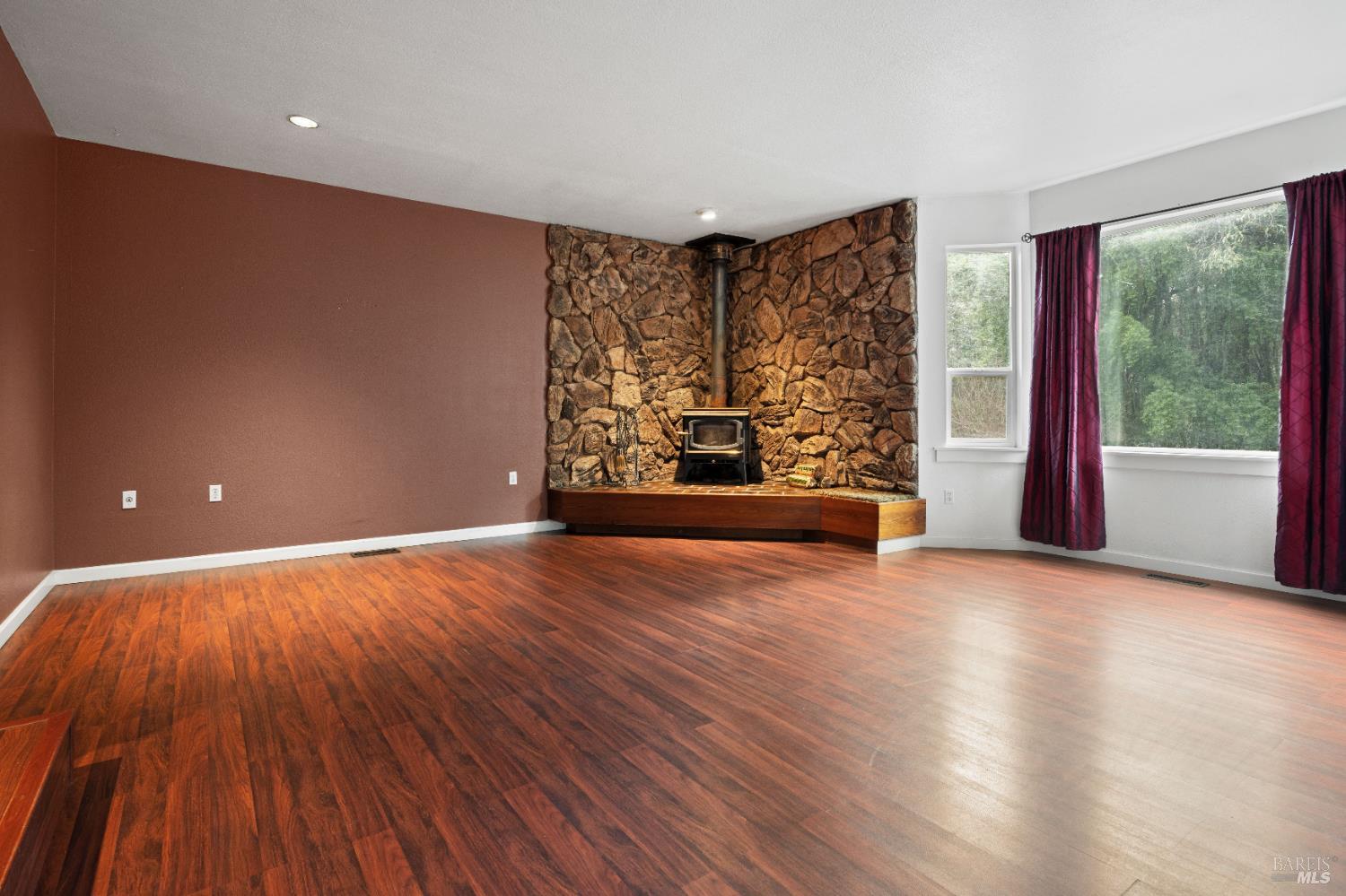 681 Branscomb Road Laytonville, CA 95454 - Photo 10 of 27 a view of an empty room with a window and wooden floor