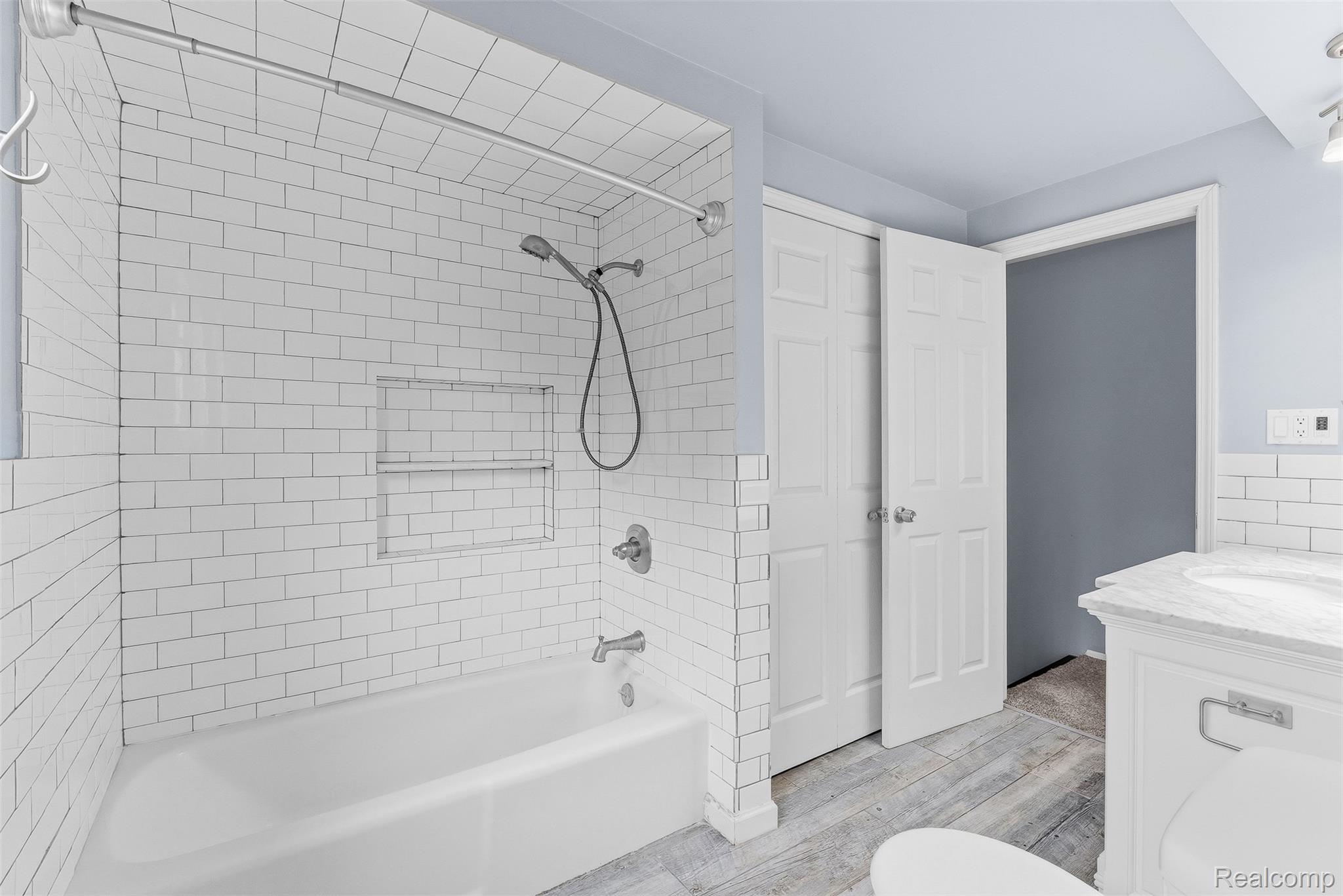 819 Alpine Trail Fenton, MI 48430 - Photo 16 of 41 White subway tile shower surround with a built-in niche, chrome fixtures, and a shower/tub combination