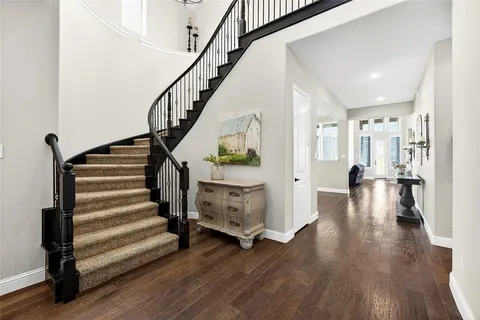 a view of entryway with wooden floor and stairs