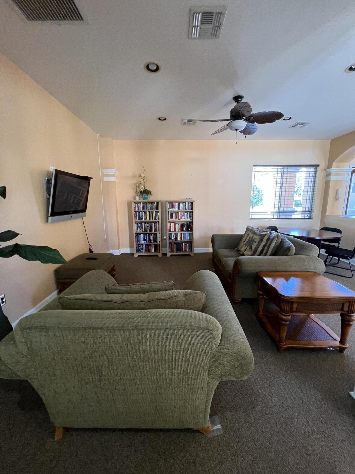 131 Southwest Palm Drive, Unit 203 Port St. Lucie, FL 34986 - Photo 7 of 13 a living room with furniture and a flat screen tv