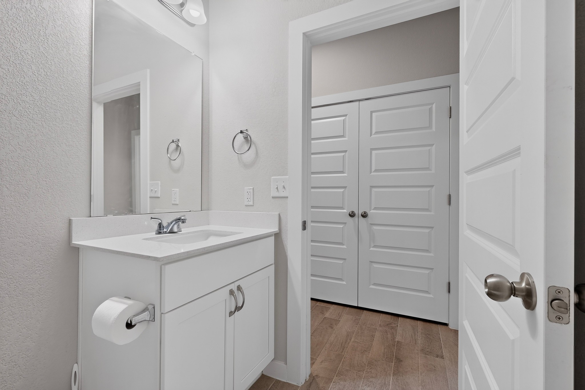 116 Appleberry Lane Elgin, TX 78621 - Photo 24 of 35 A well-appointed bathroom features a single vanity with a sleek countertop and a large mirror.