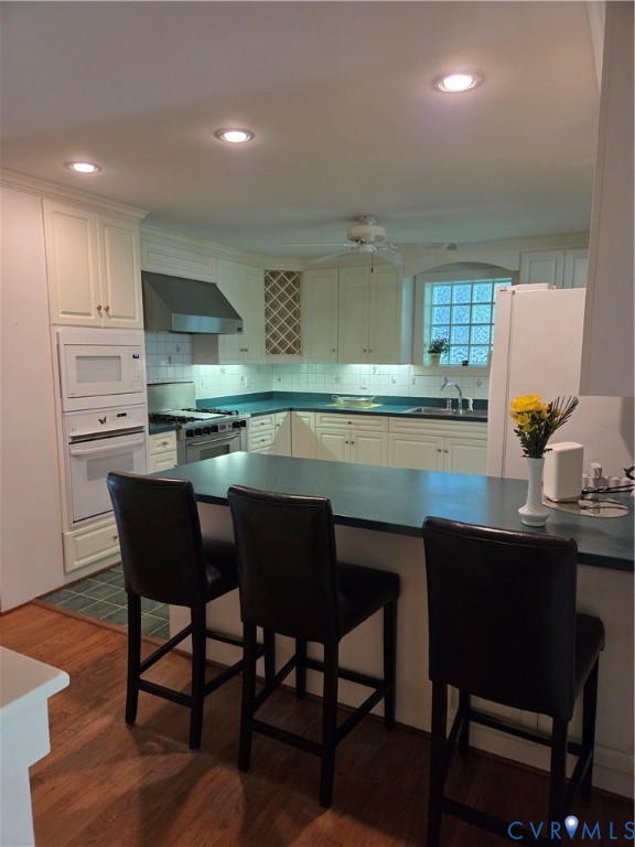 7733 Rock Creek Road Henrico, VA 23229 - Photo 16 of 73 a kitchen with a table chairs sink and cabinets
